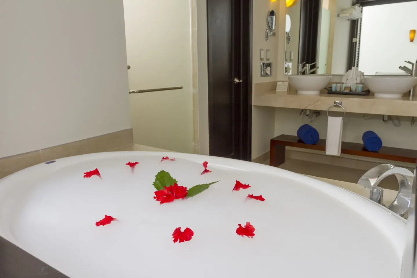 Petal-decorated tub in a Deluxe Select room at Sandos Caracol Nature Resort & Water Park.