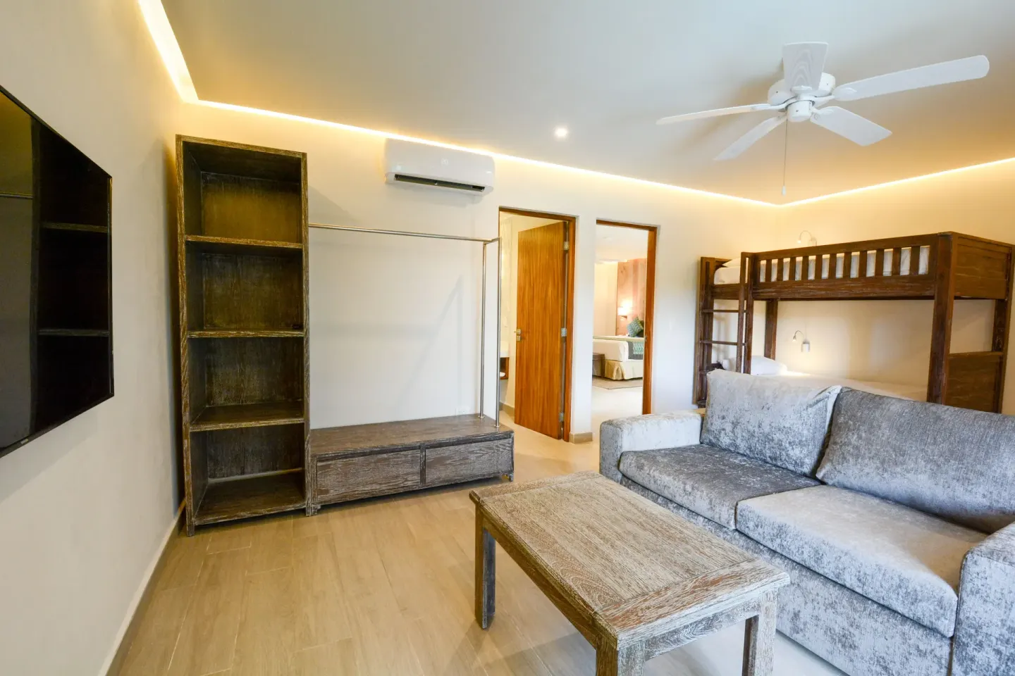 Eco Family Penthouse living area with bunk bed and sofa at Sandos Caracol Nature Resort & Water Park.