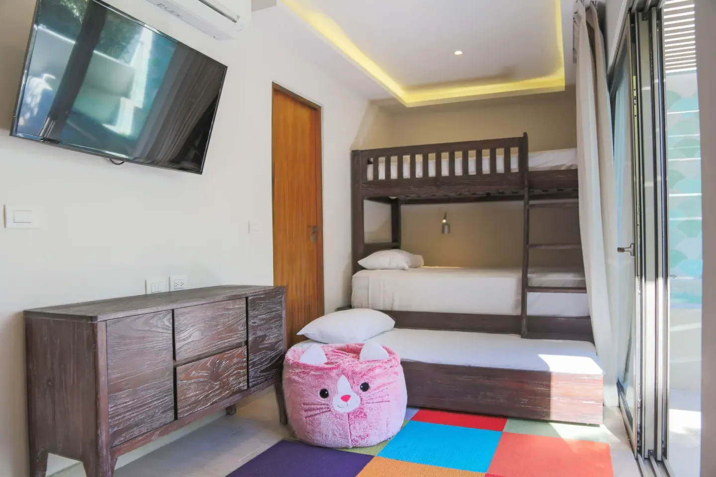 Eco Junior Suite kids' bunk room with TV at Sandos Caracol Nature Resort & Water Park.