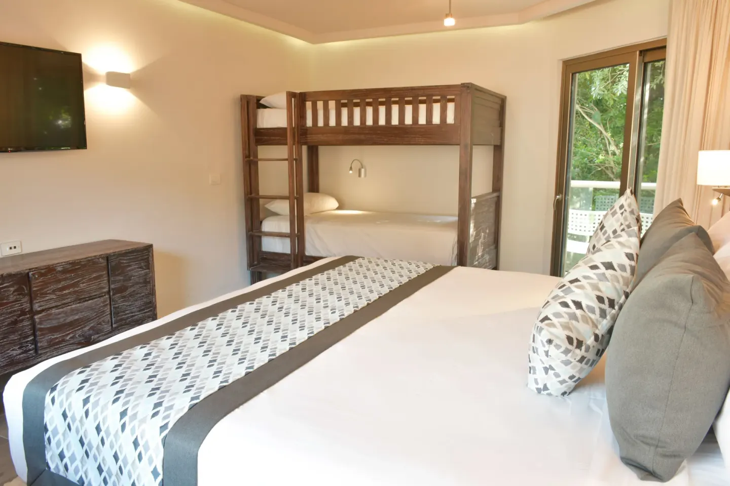 Eco Family Superior king bed and bunk beds at Sandos Caracol Nature Resort & Water Park.