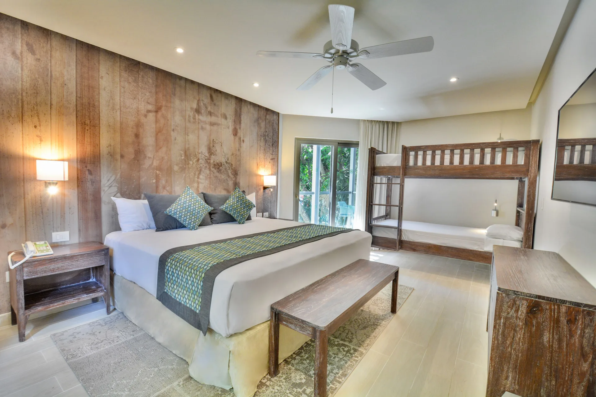 Eco Family Superior king bed, bunk beds, and dresser at Sandos Caracol Nature Resort & Water Park.