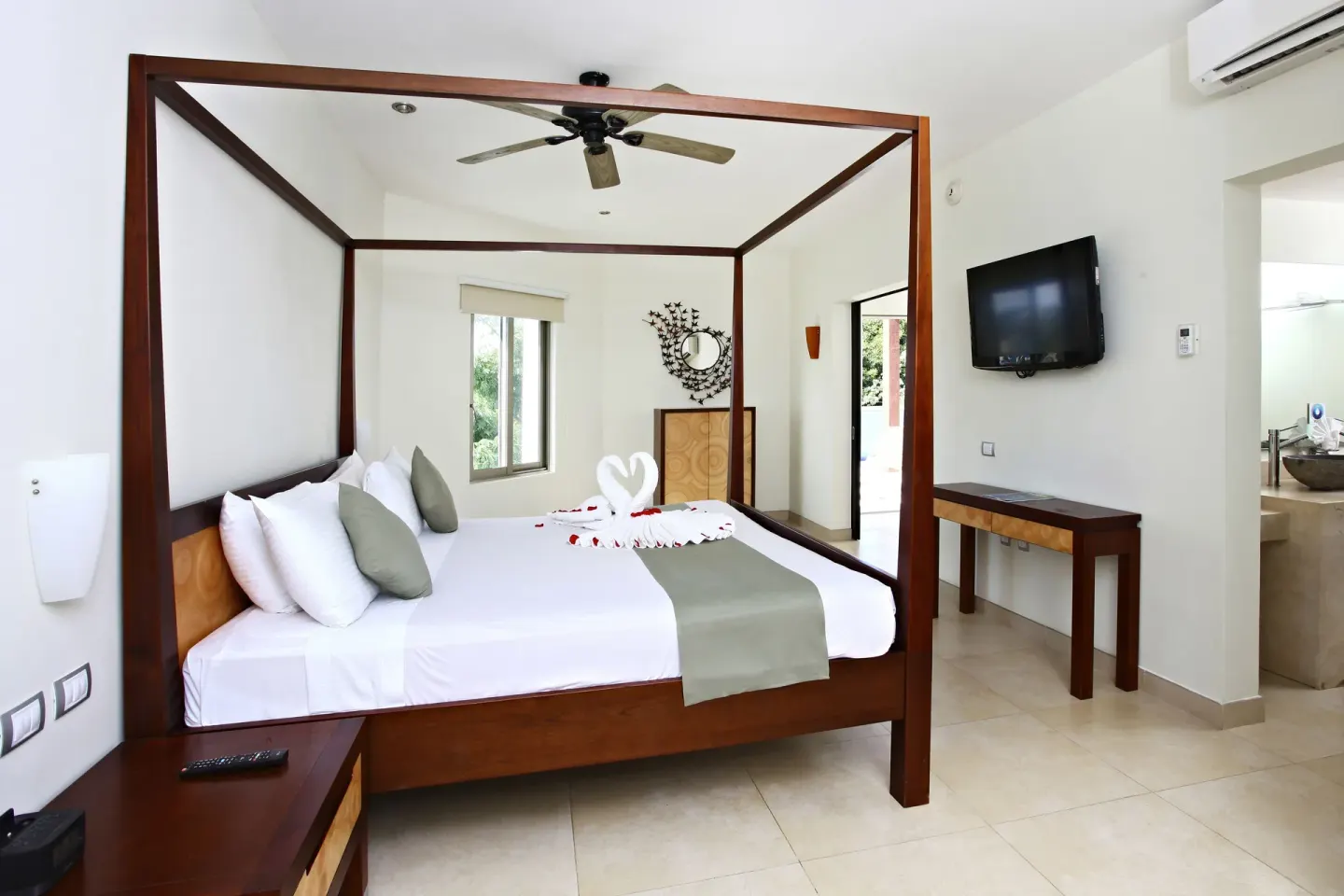 Penthouse Select adults-only bedroom with four-poster king bed at Sandos Caracol Nature Resort & Water Park.