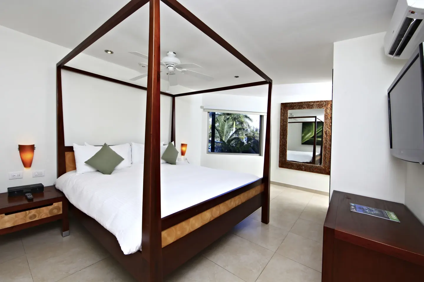Pool View 1 Bedroom Suite bedroom with canopy bed at Sandos Caracol Nature Resort & Water Park.