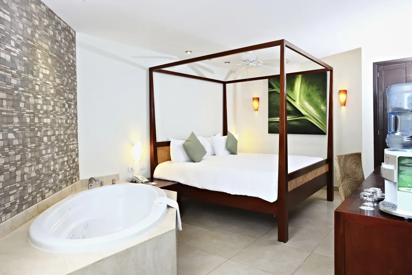 Pool View Penthouse canopy king bed and soaking tub at Sandos Caracol Nature Resort & Water Park.