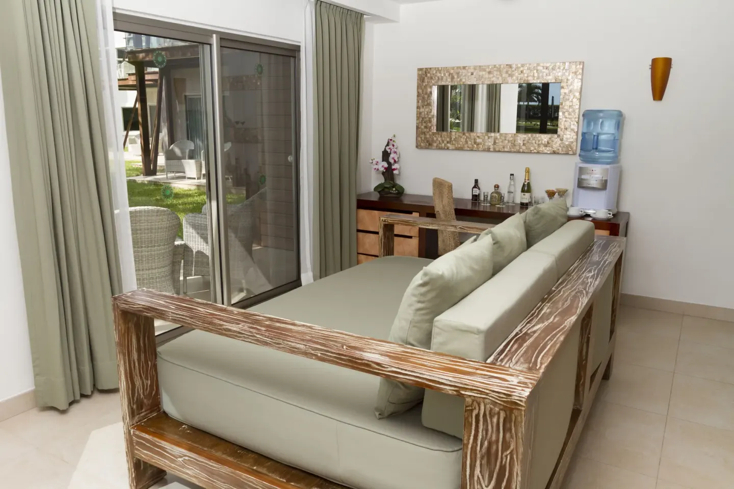 Pool View Penthouse lounge area with sliding terrace doors at Sandos Caracol Nature Resort & Water Park.