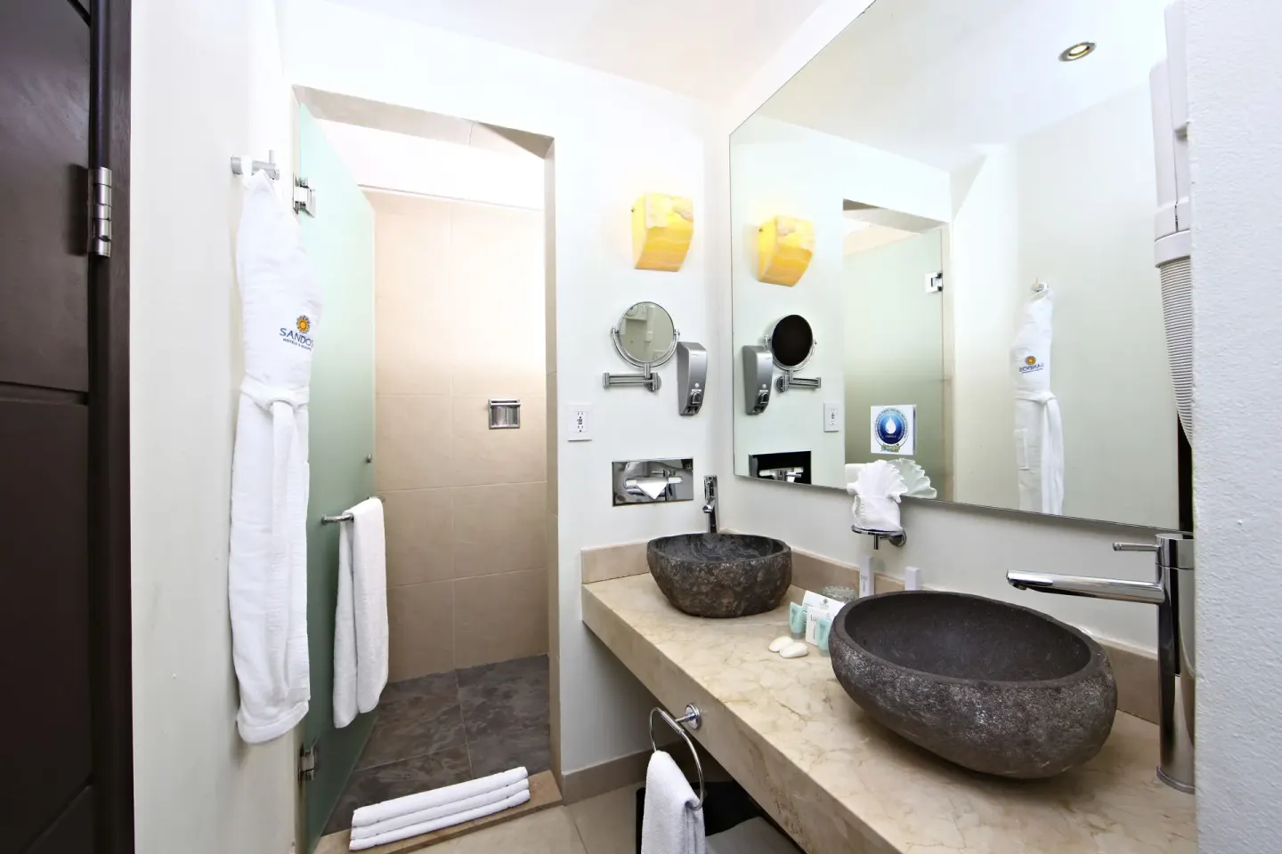 Pool View Superior bathroom with stone vessel sinks at Sandos Caracol Nature Resort & Water Park.