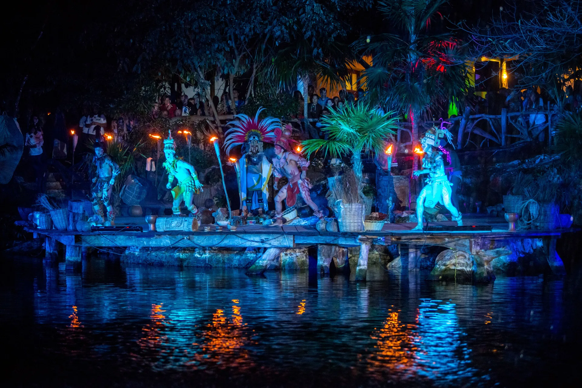 Night performance on a waterside stage at Sandos Caracol Nature Resort & Water Park.