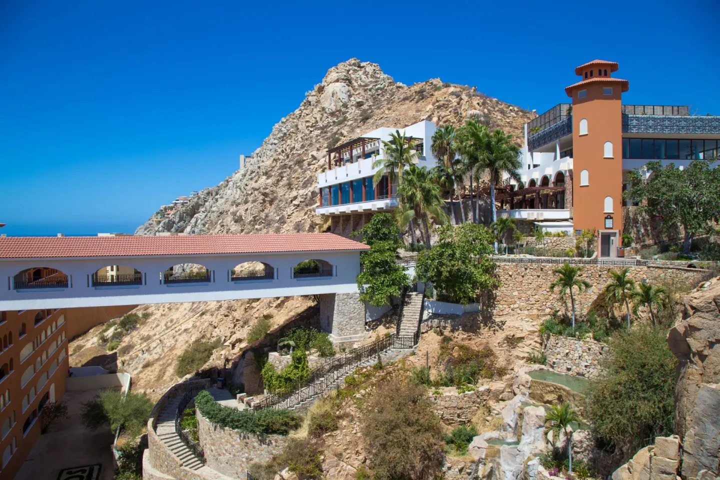 Cliffside resort buildings and arched walkway at Sandos Finisterra.