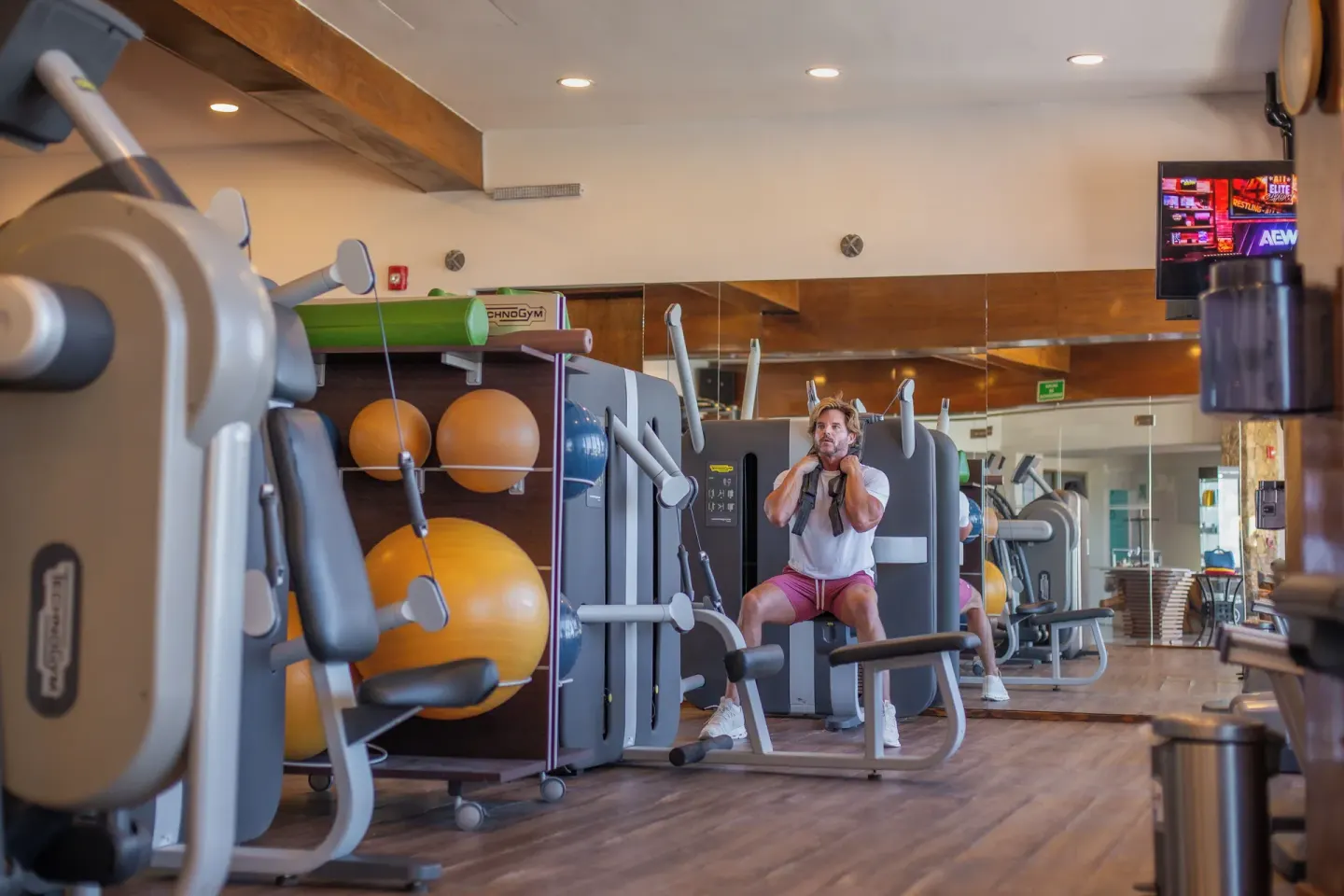 Guest uses a strength machine in the fitness center at Sandos Finisterra.