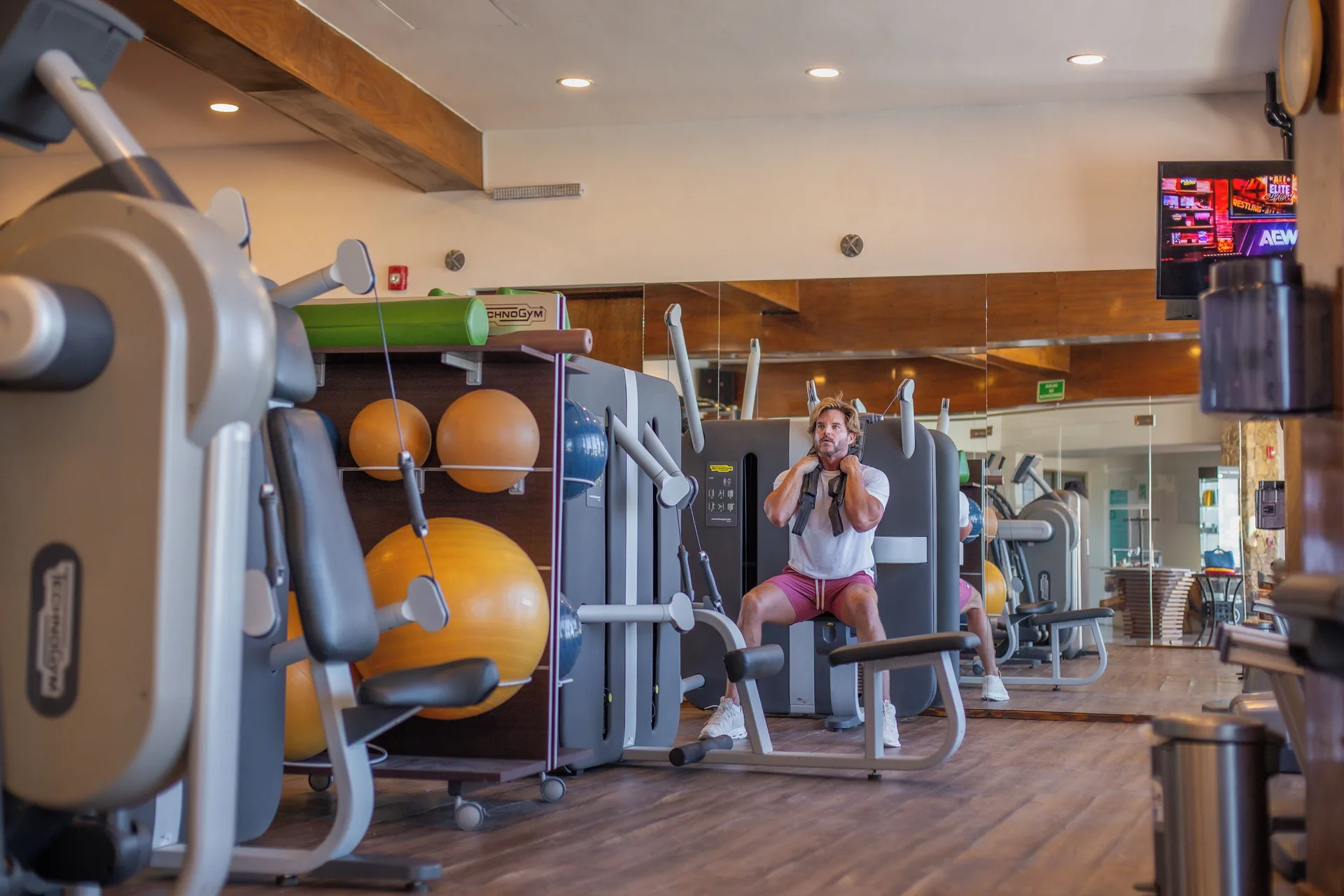 Guest uses a strength machine in the fitness center at Sandos Finisterra.