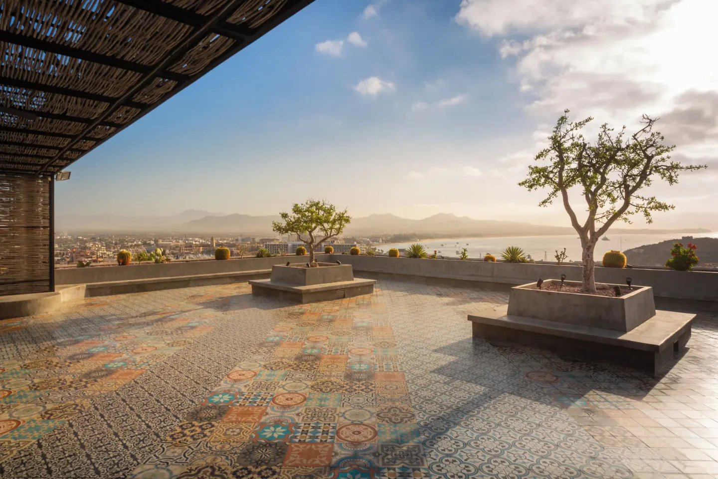 Patterned terrace with planters and ocean views at Sandos Finisterra.