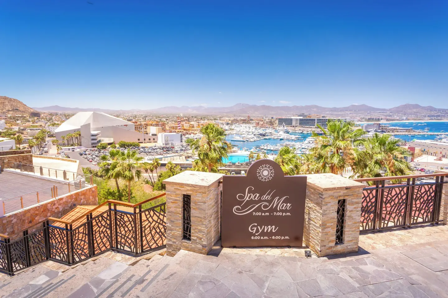 Spa and gym sign overlooks the marina from a stone terrace at Sandos Finisterra.
