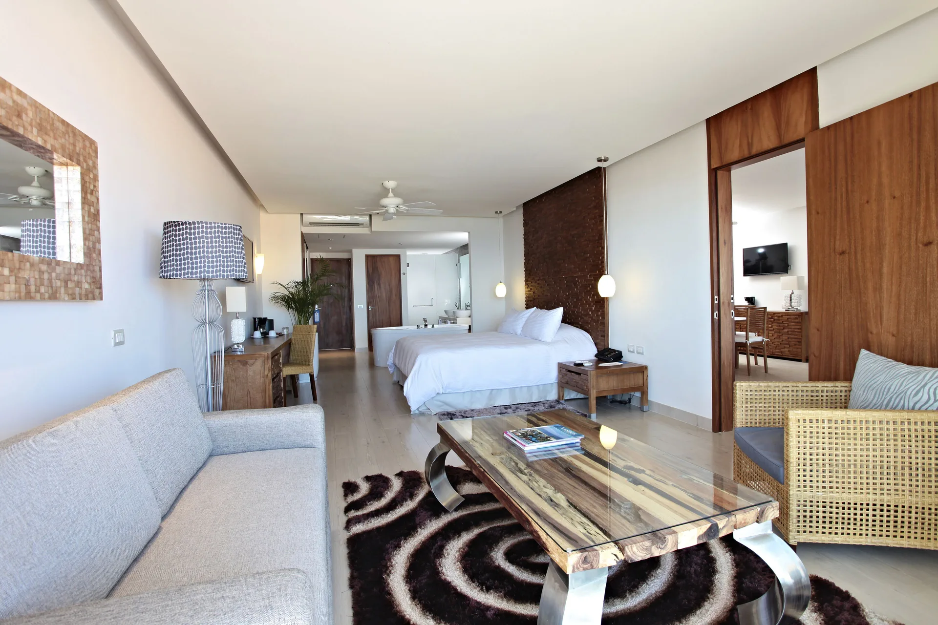 Spacious suite with king bed, sofa and sitting area at Sandos Finisterra.