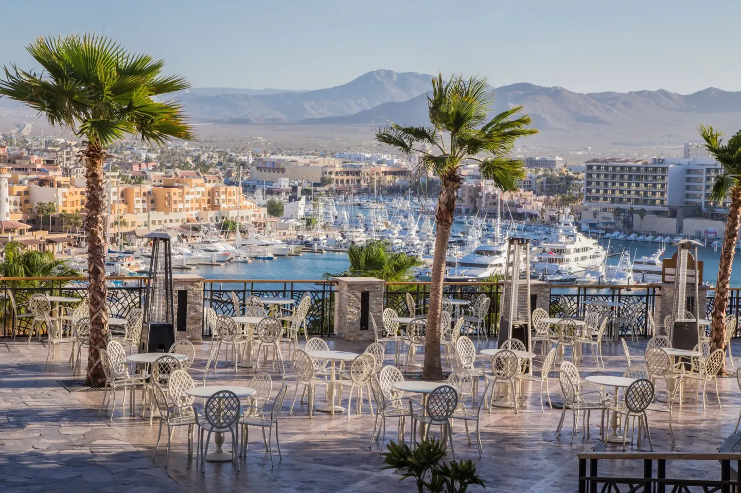Terrace seating overlooks the marina and mountains at Sandos Finisterra.