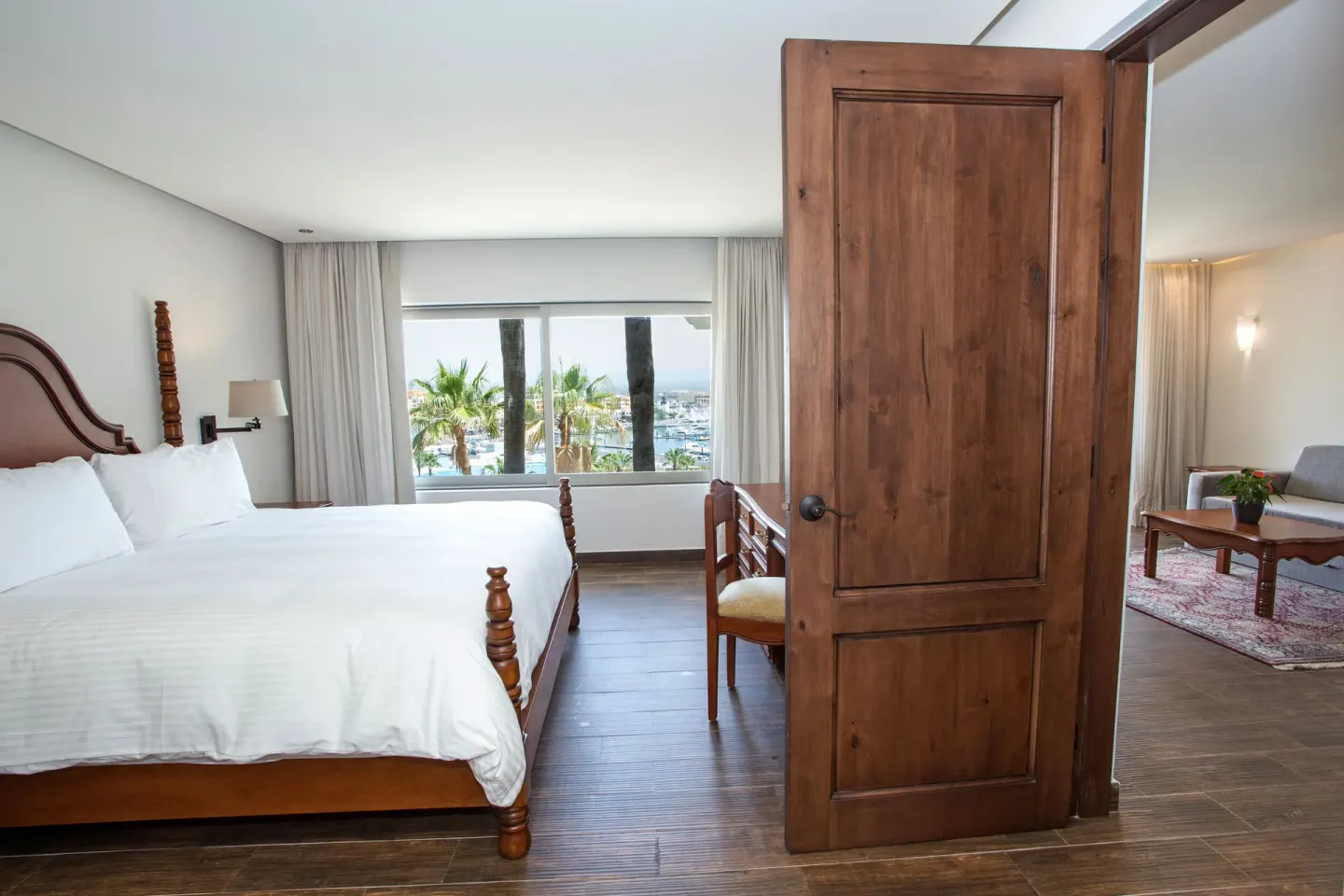 Casita Suite king bedroom connected to a separate living room at Sandos Finisterra.