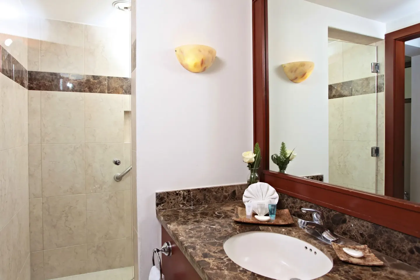 Marina Bay View bathroom with sink and glass shower at Sandos Finisterra.