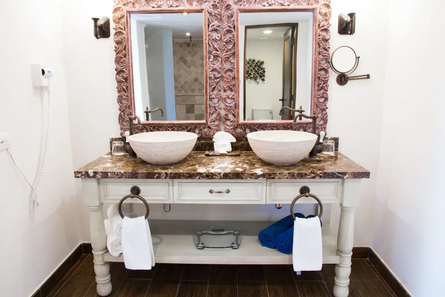 Marina Bay View bathroom double vanity with carved mirrors at Sandos Finisterra.