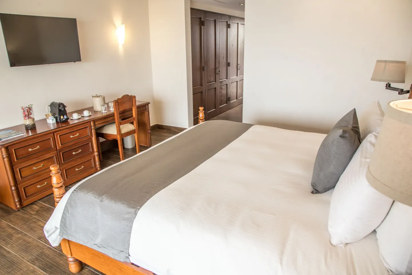 Marina Bay View king bed room with dresser and wardrobe at Sandos Finisterra.