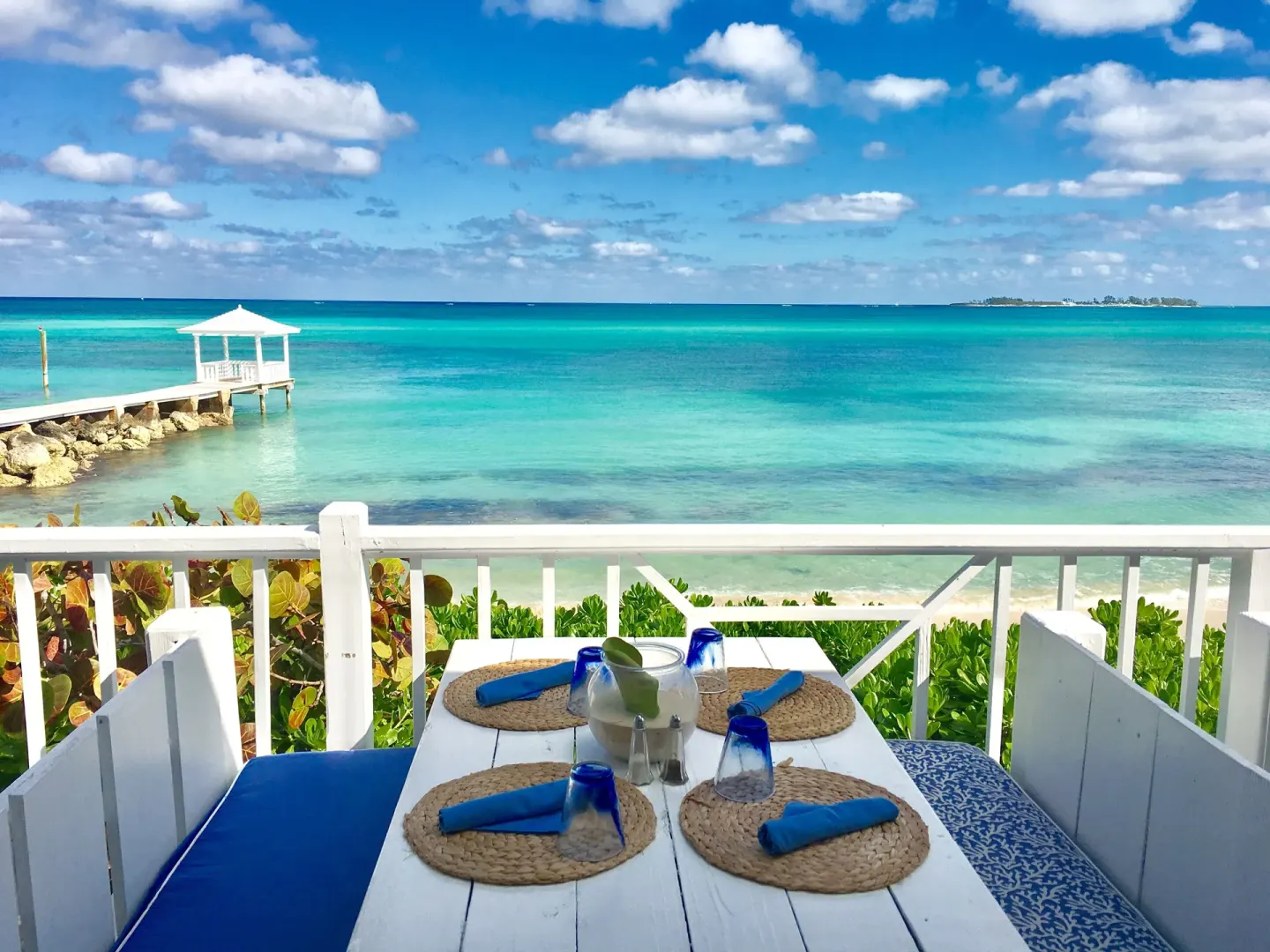 Oceanfront table setting overlooking turquoise water at Sandyport Beach Resort.