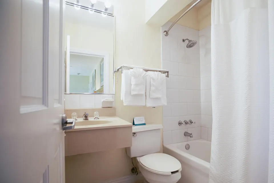 Standard Studio bathroom with tub shower at Sandyport Beach Resort.