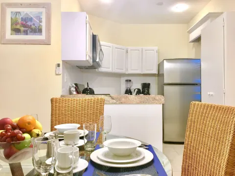 Dining table set in front of the suite kitchen at Sandyport Beach Resort.