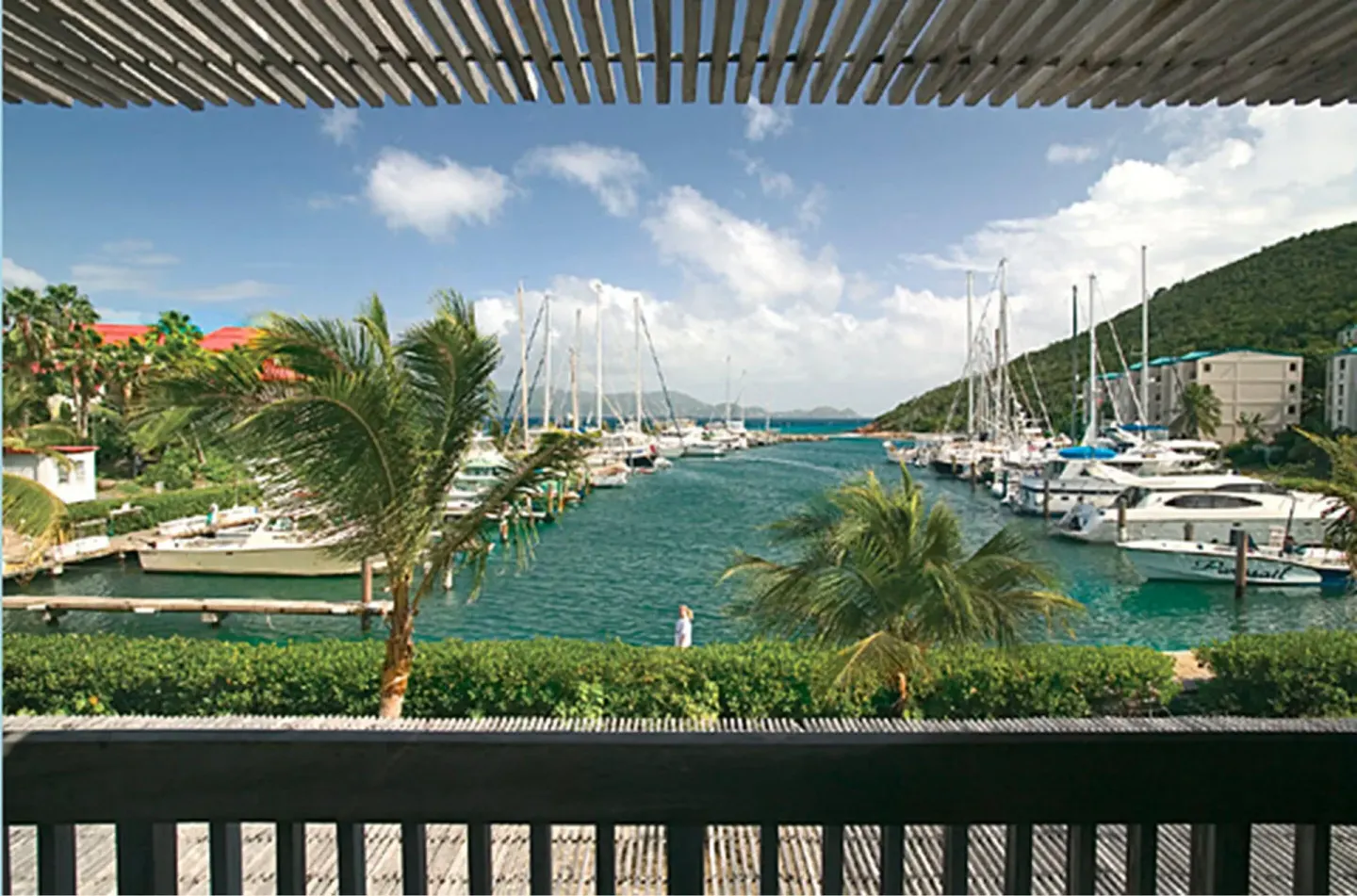 Covered balcony view of the marina and boats at Sapphire Beach Resort.
