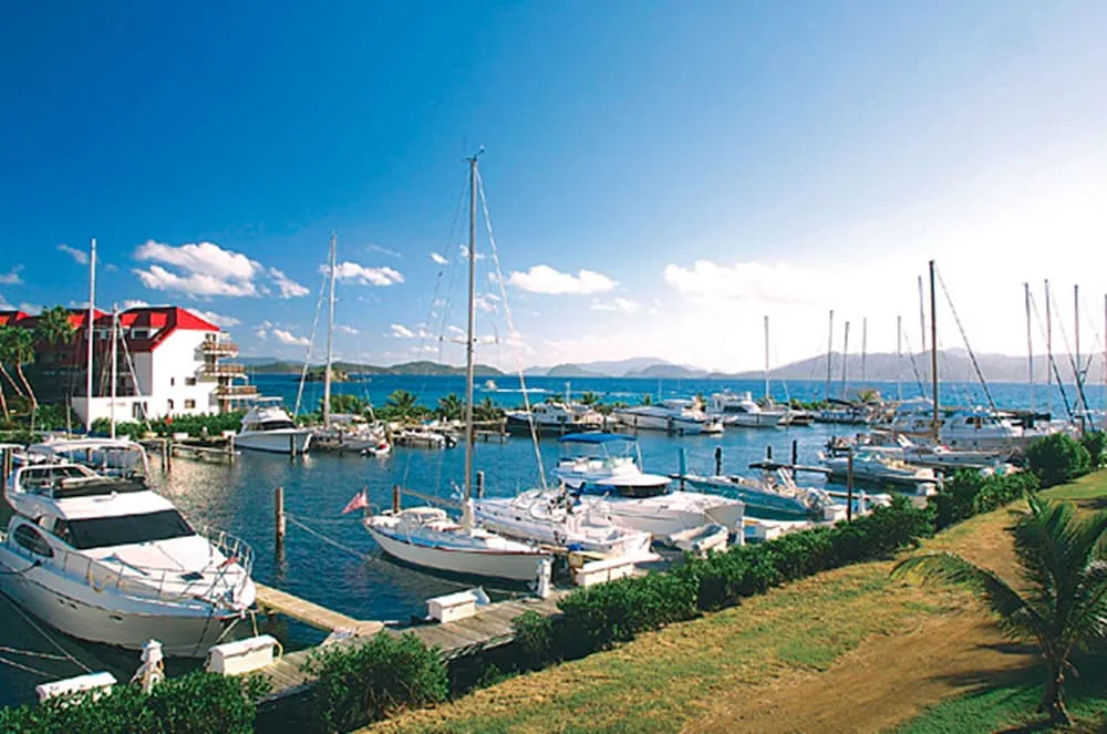 Sunny marina with yachts and distant islands at Sapphire Beach Resort.