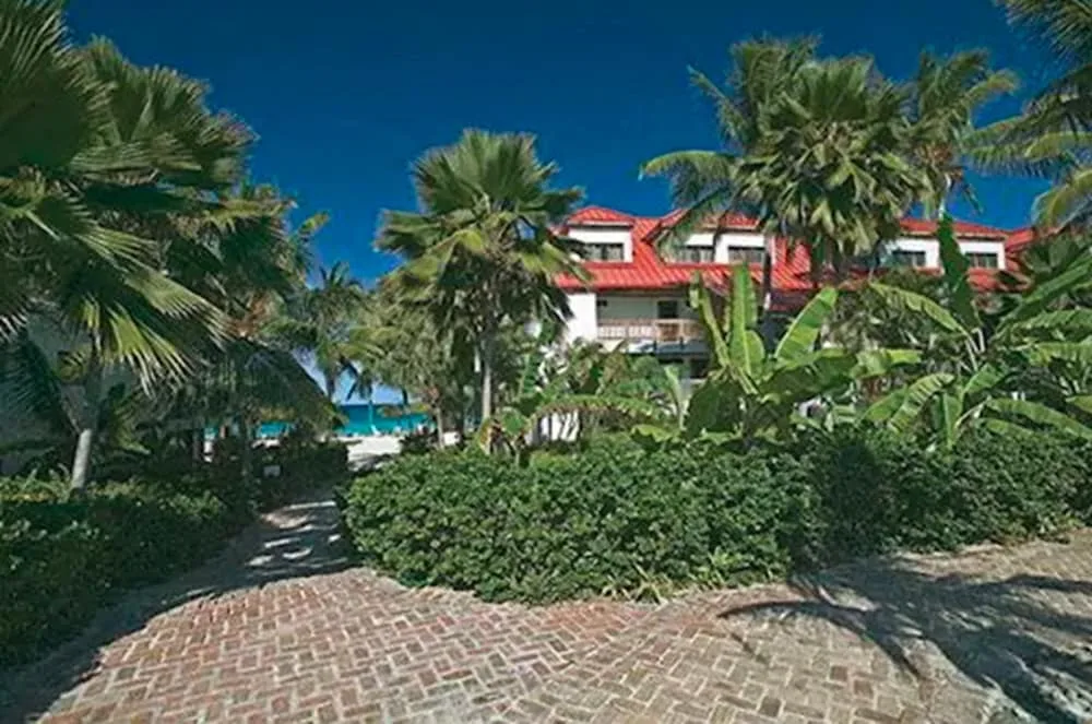 Tropical garden walkway and red-roofed buildings at Sapphire Beach Resort.