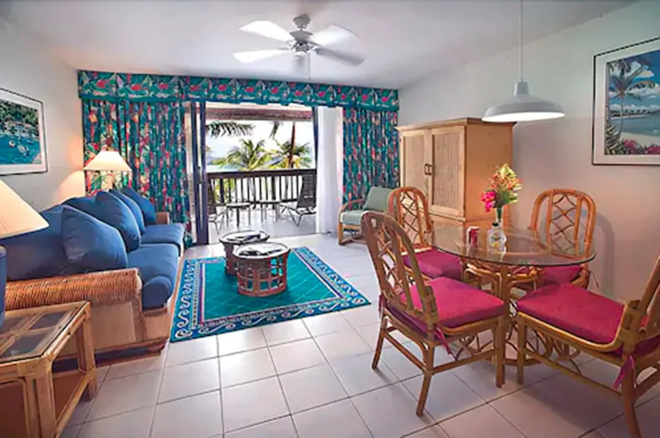 Beachfront villa living and dining area with balcony at Sapphire Beach Resort.