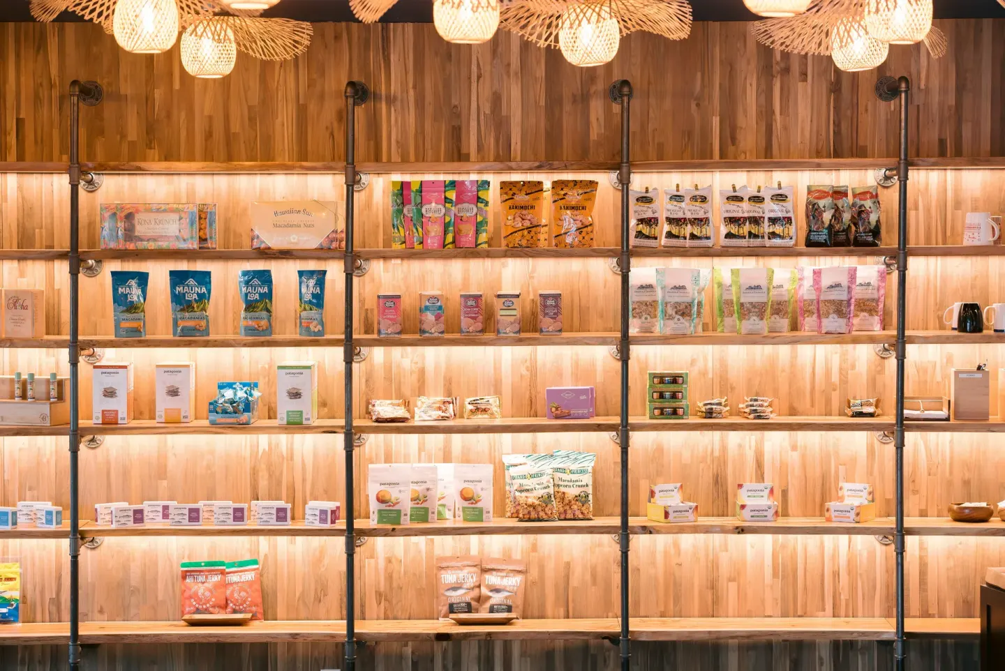 Backlit market shelves display packaged snacks and goods at SCP Hilo Hotel.
