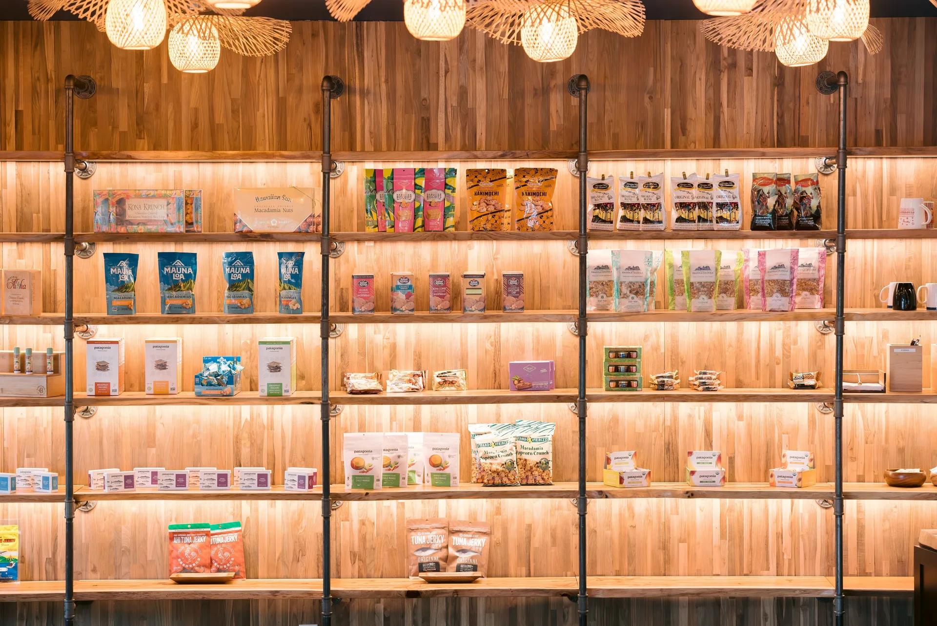 Backlit market shelves display packaged snacks and goods at SCP Hilo Hotel.