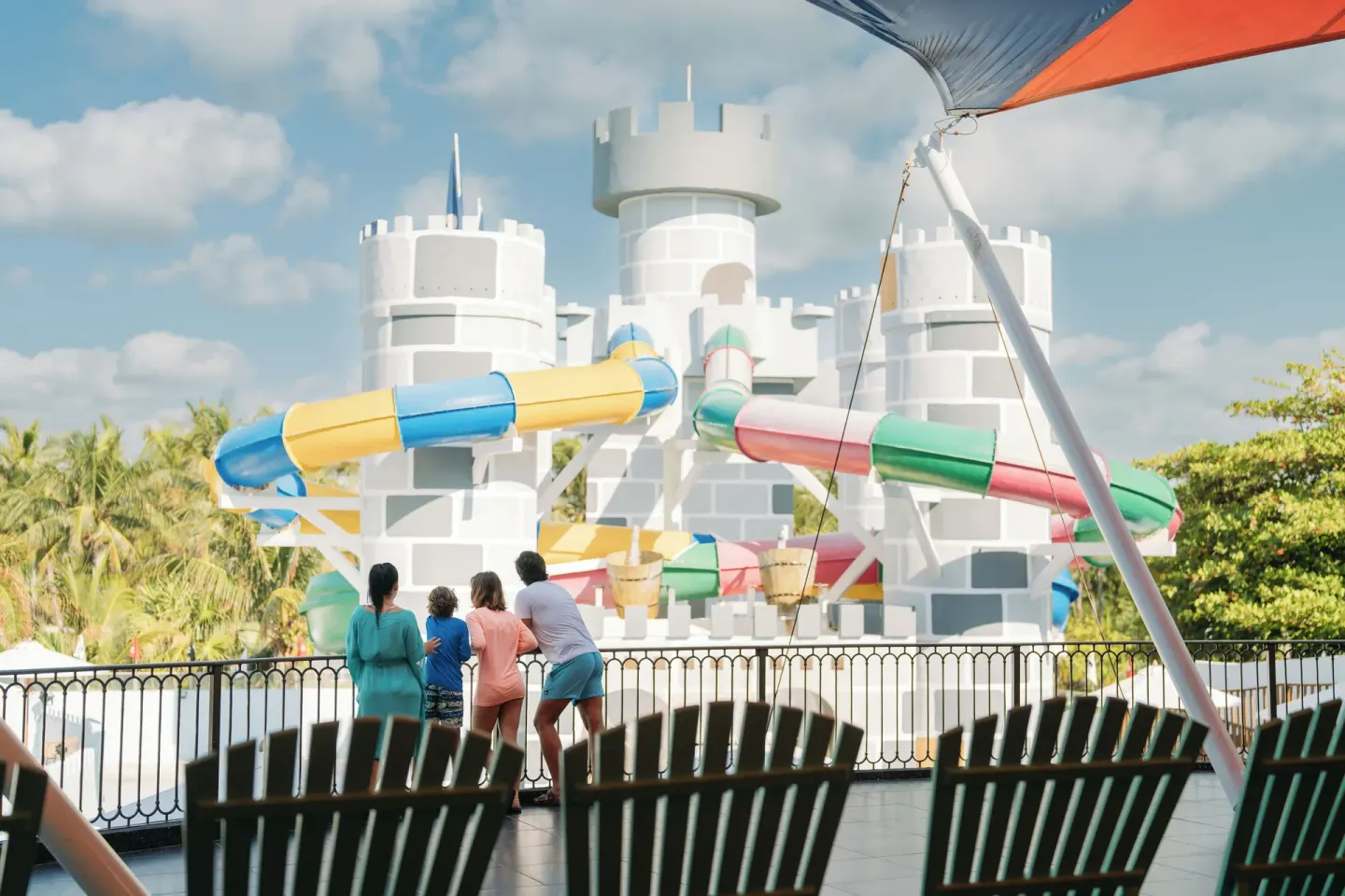 Castle-themed waterslides and seating area at Seadust Cancún Family Resort.