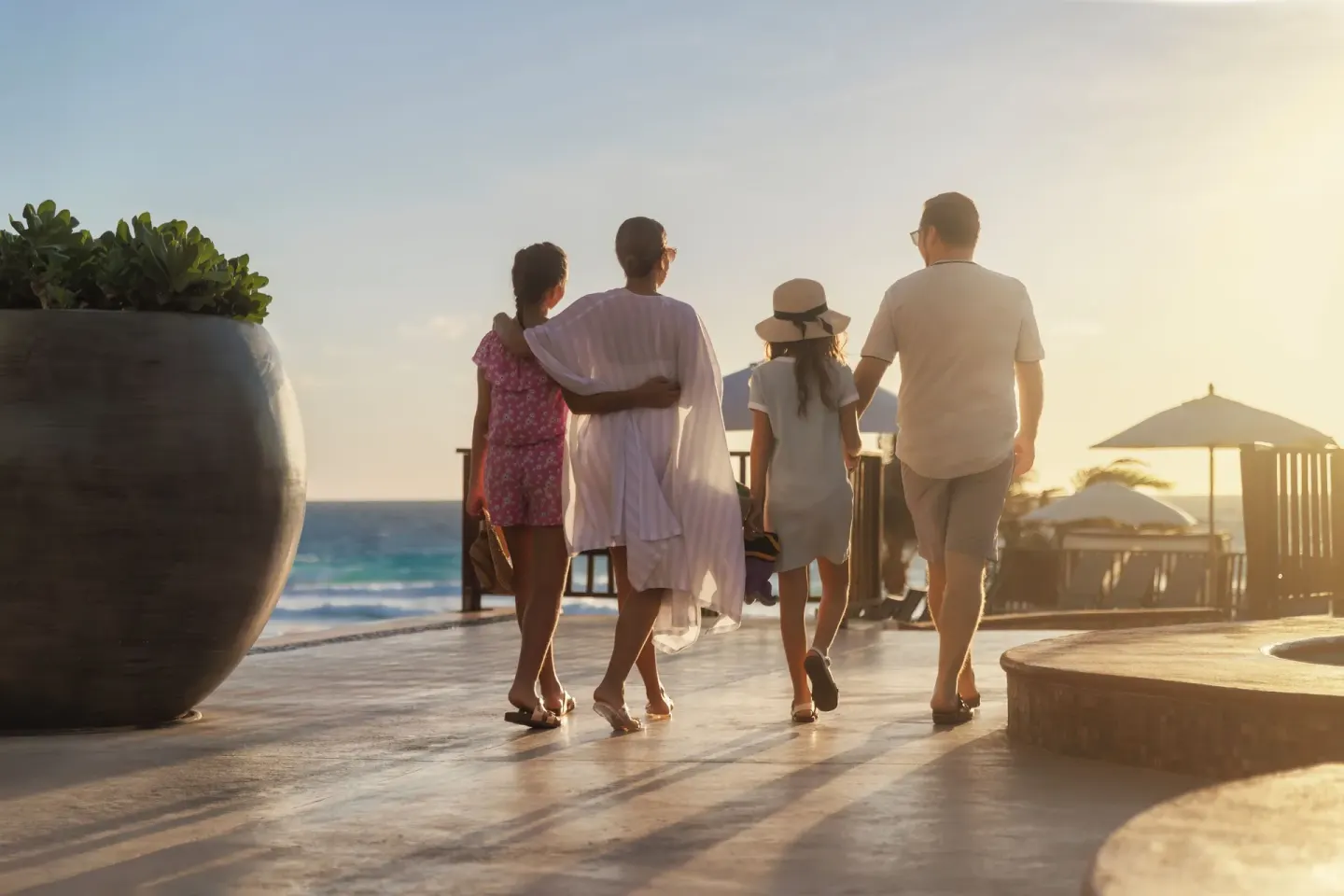 Family walks along an oceanfront terrace at Seadust Cancún Family Resort.