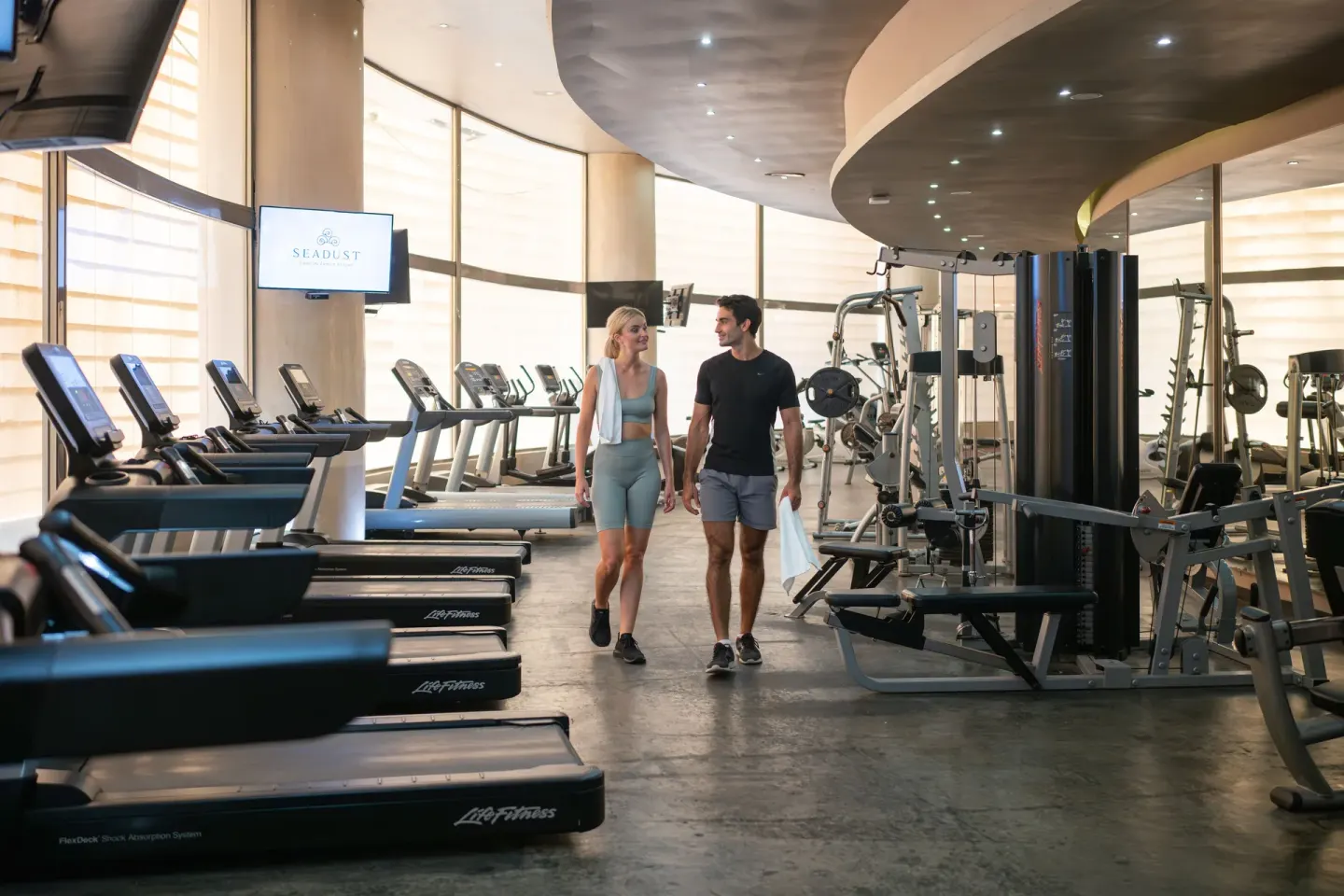 Fitness center with treadmills and weight equipment at Seadust Cancún Family Resort.
