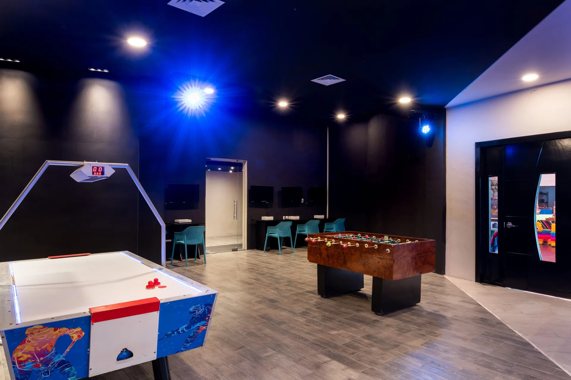 An indoor game room with air hockey and foosball tables at Seadust Cancún Family Resort.