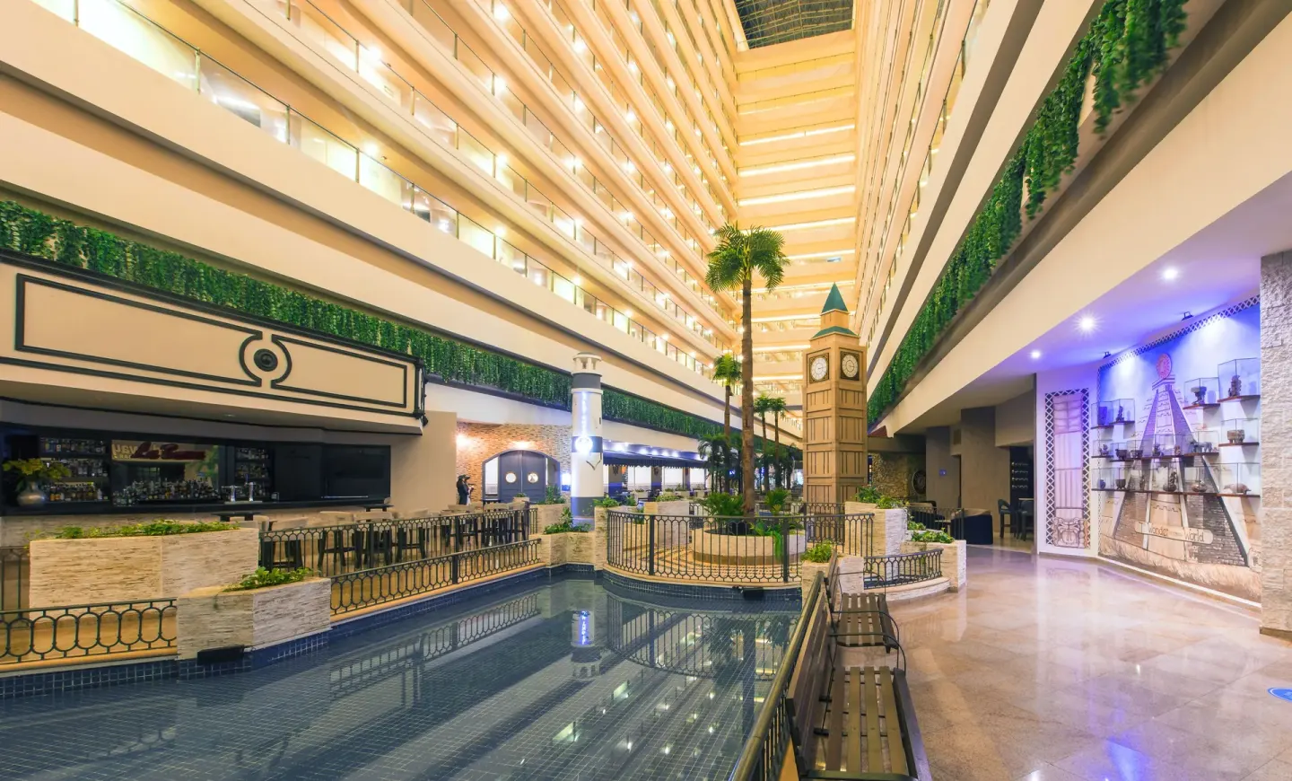 Indoor atrium with water feature and clock tower at Seadust Cancún Family Resort.