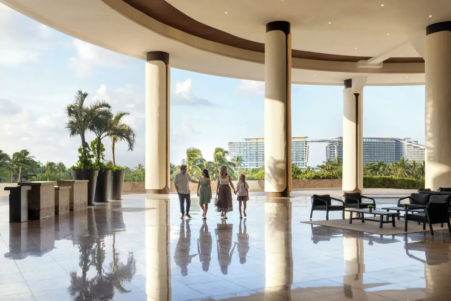 Open-air lobby terrace with columns and seating at Seadust Cancún Family Resort.