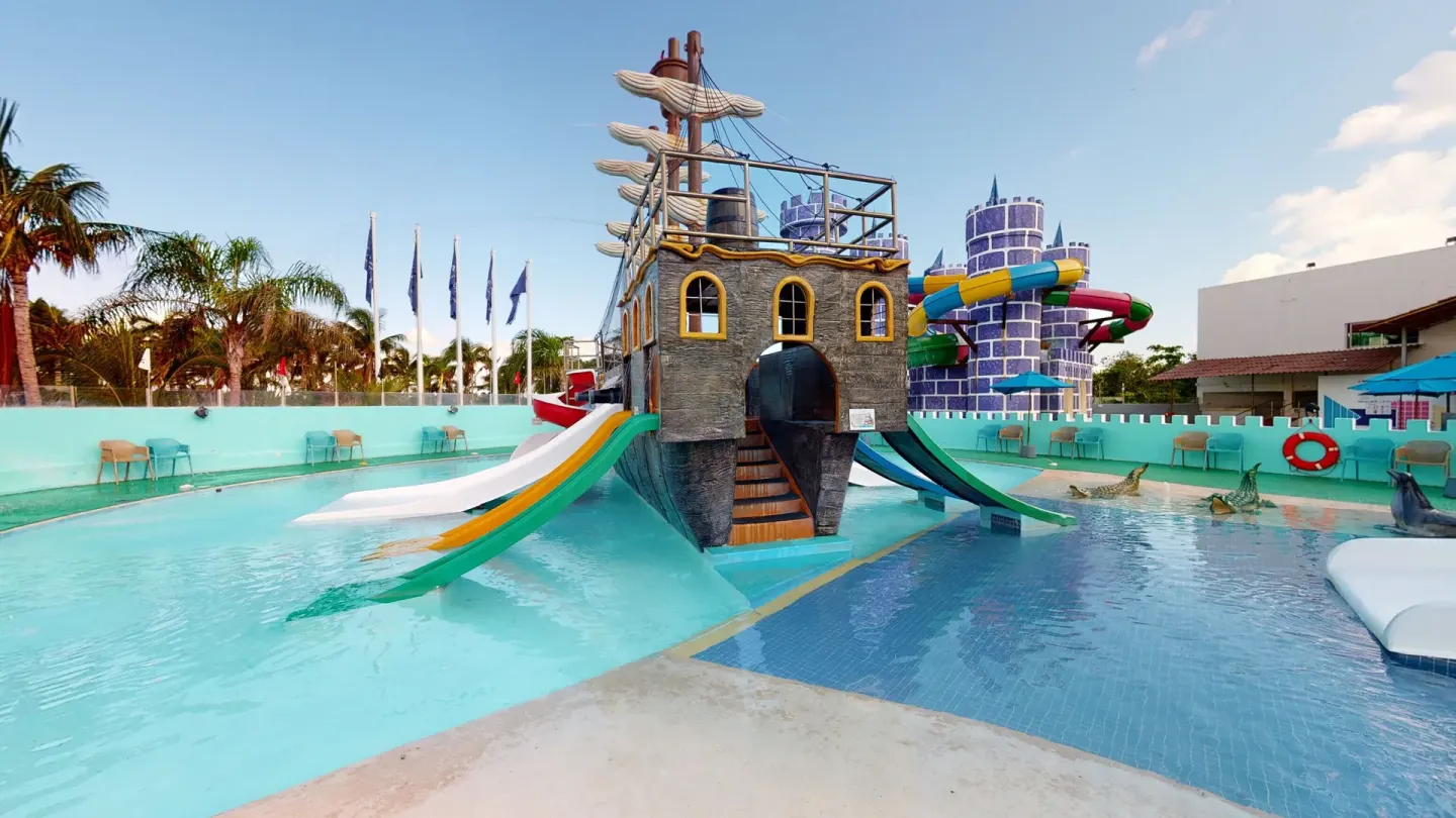 Pirate ship splash area with slides at Seadust Cancún Family Resort.