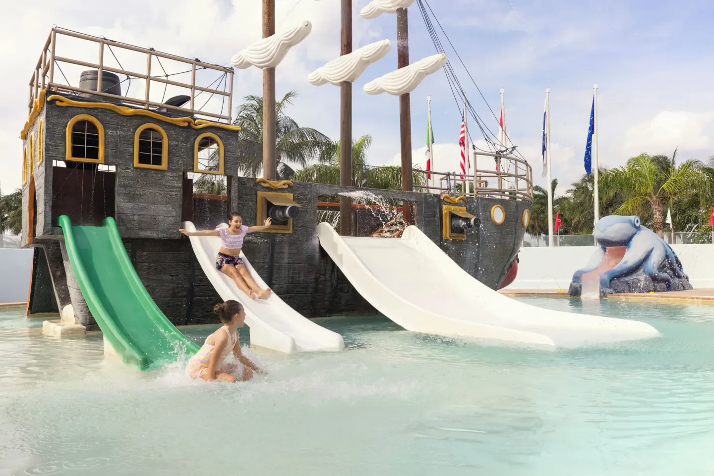 Pirate ship splash pool with slides at Seadust Cancún Family Resort.