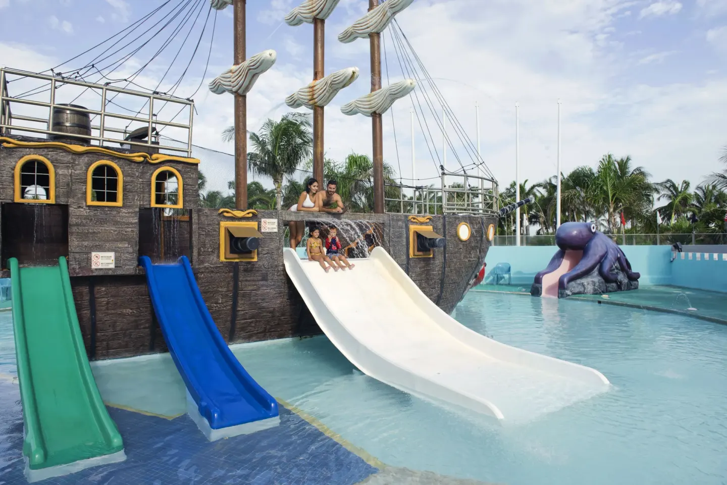 Children on pirate ship water slides at Seadust Cancún Family Resort.