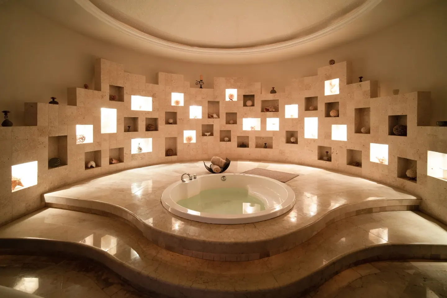 Spa soaking tub with illuminated wall niches at Seadust Cancún Family Resort.