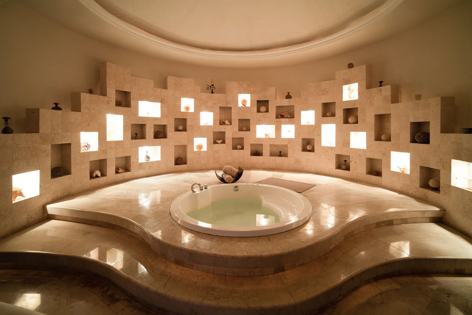Spa soaking tub with illuminated wall niches at Seadust Cancún Family Resort.