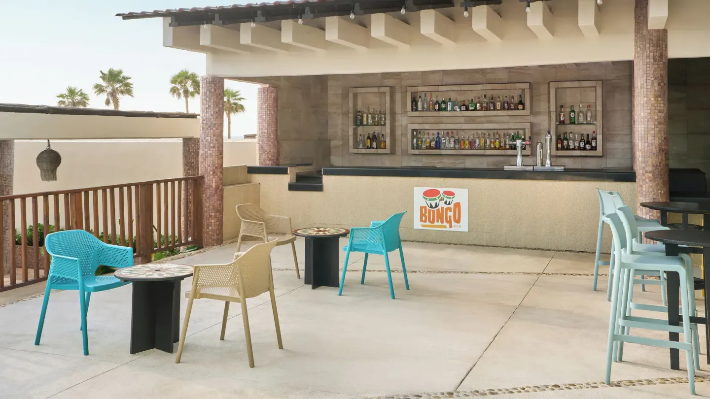Bongo bar terrace with colorful chairs at Seadust Cancún Family Resort.