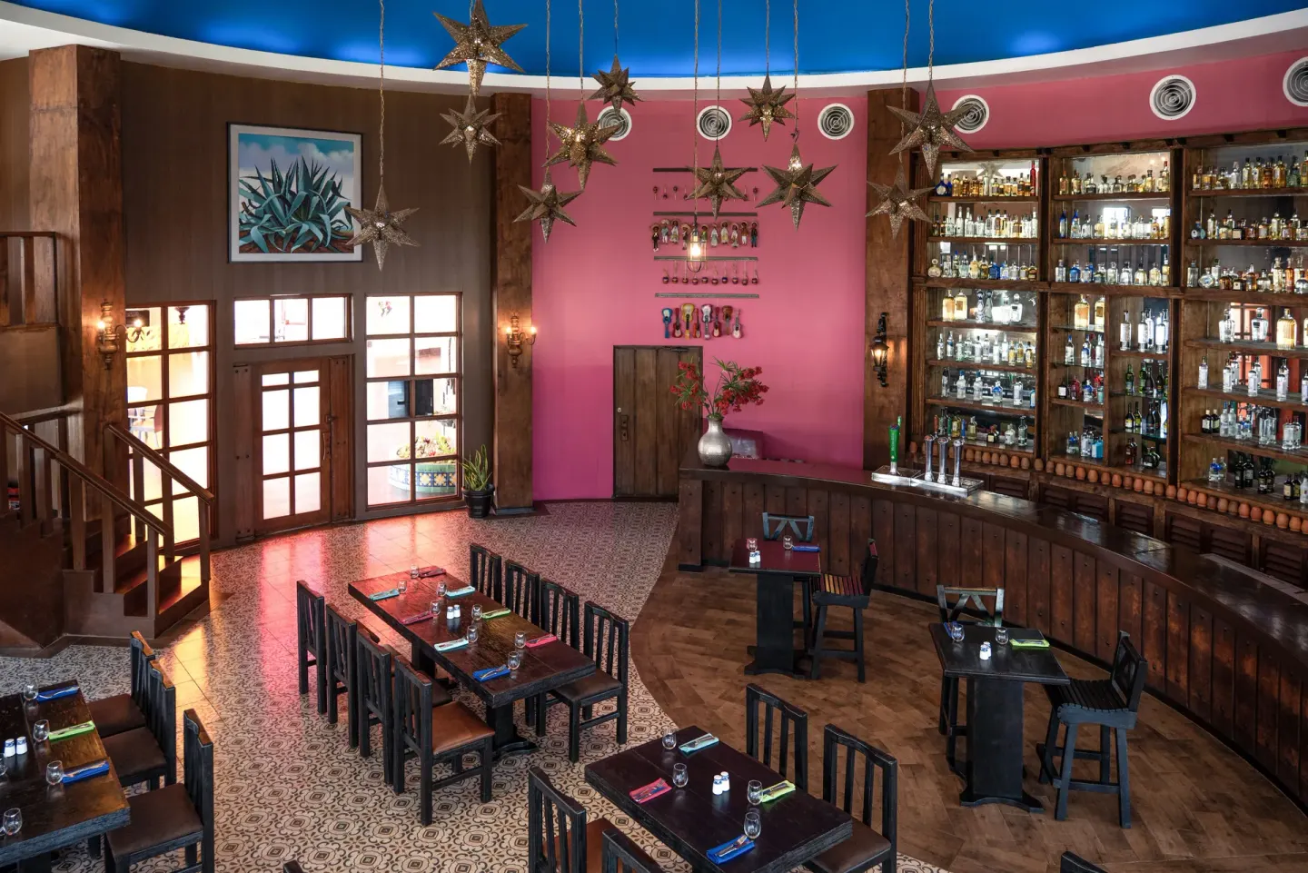 Colorful bar with bottle displays and star lanterns at Seadust Cancún Family Resort.