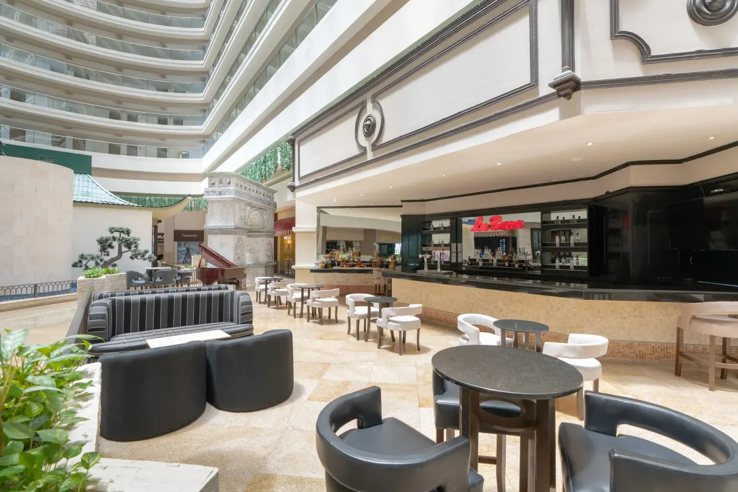 La Barra seating and bar counter in the atrium at Seadust Cancún Family Resort.