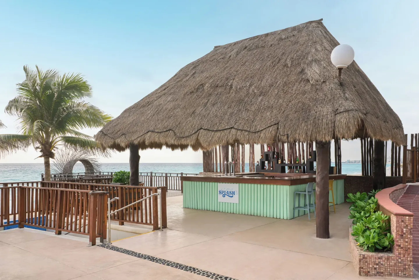 Splash beach bar under a thatched roof at Seadust Cancún Family Resort.