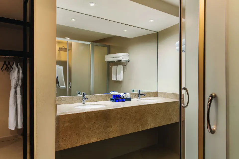 Family Suite bathroom vanity with double sinks at Seadust Cancún Family Resort.