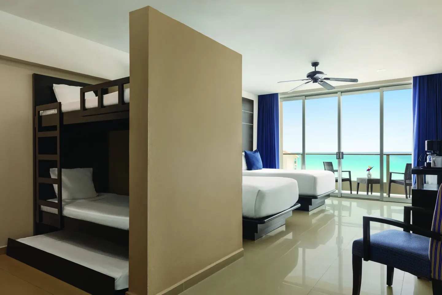 Family Suite with bunk beds and ocean-facing balcony at Seadust Cancún Family Resort.