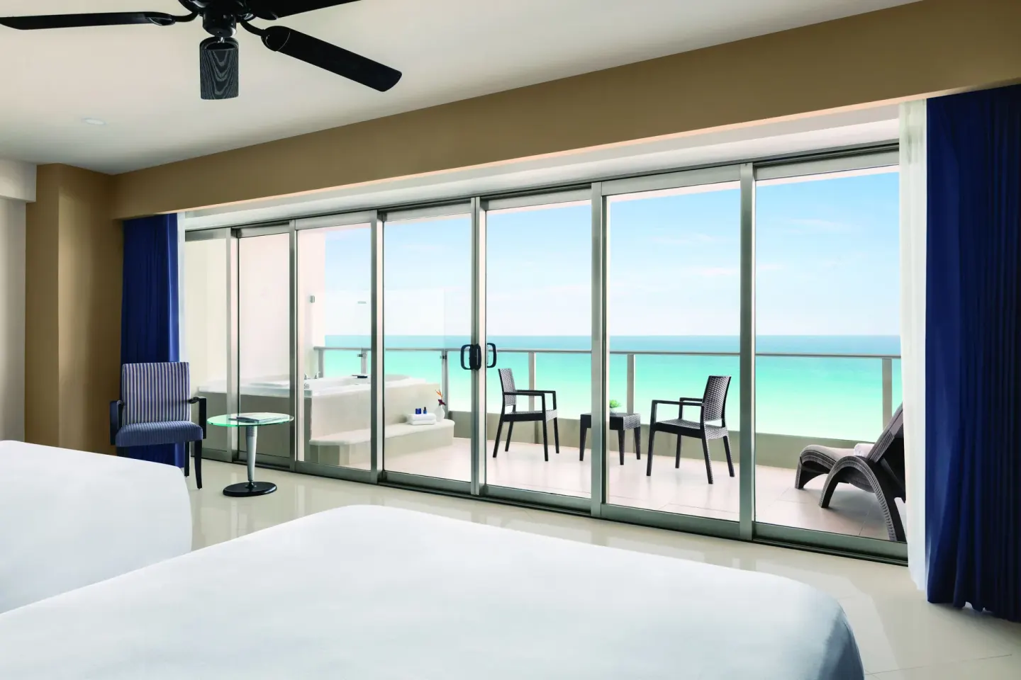 Oceanfront Suite with two beds and balcony view at Seadust Cancún Family Resort.