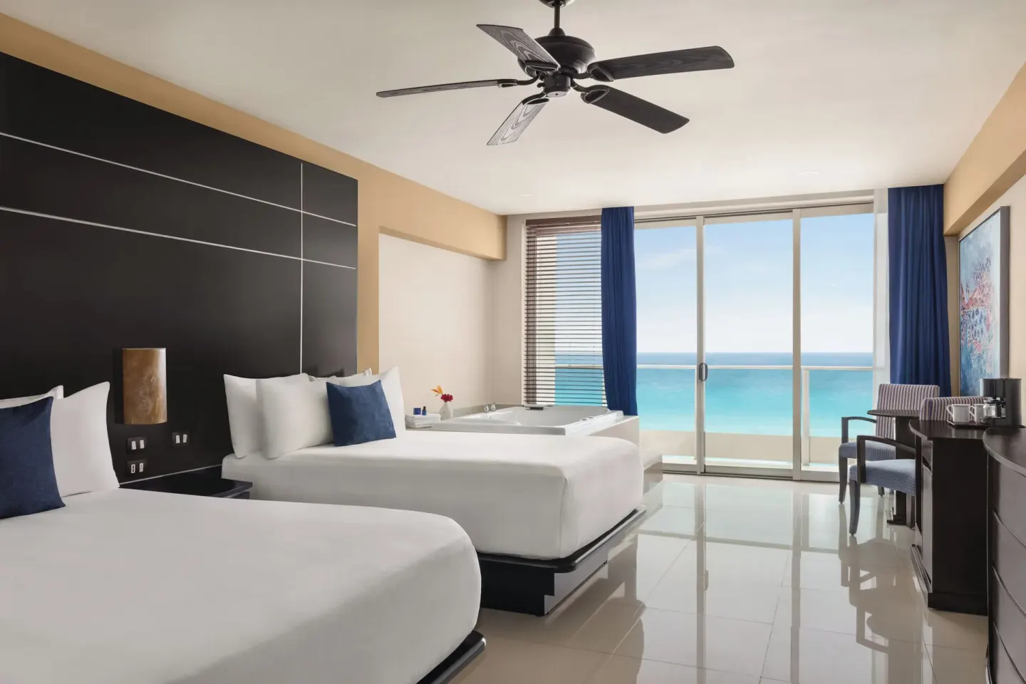 Premier Suite with two beds, soaking tub and ocean-facing balcony at Seadust Cancún Family Resort.